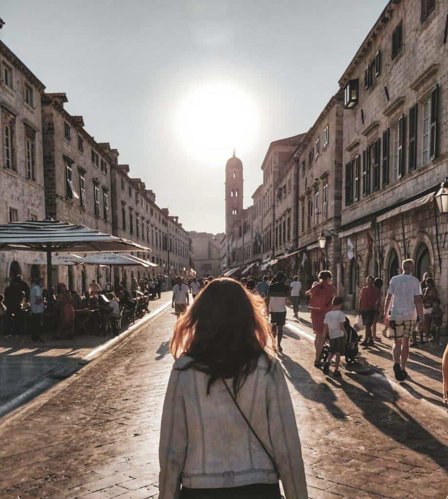 Simina walking in the Old Town of Dubrovnik with the sun behind